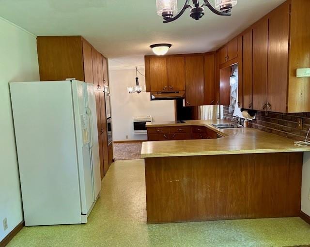 22025 Ness Rd, Parsons, KS 67357 - kitchen featuring white fridge with ice dispenser, a chandelier, a peninsula, brown cabinetry, and a sink