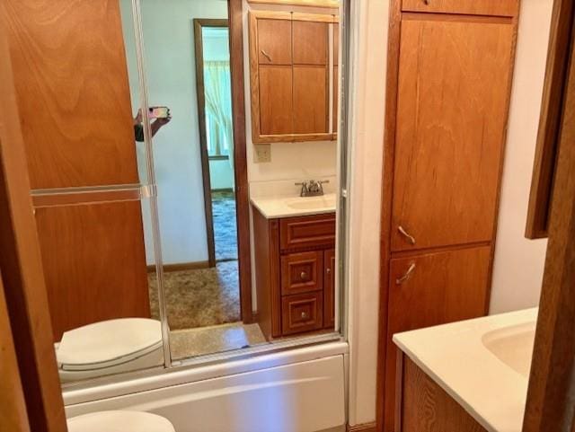 22025 Ness Rd, Parsons, KS 67357 - full bathroom featuring vanity, toilet, and enclosed tub / shower combo