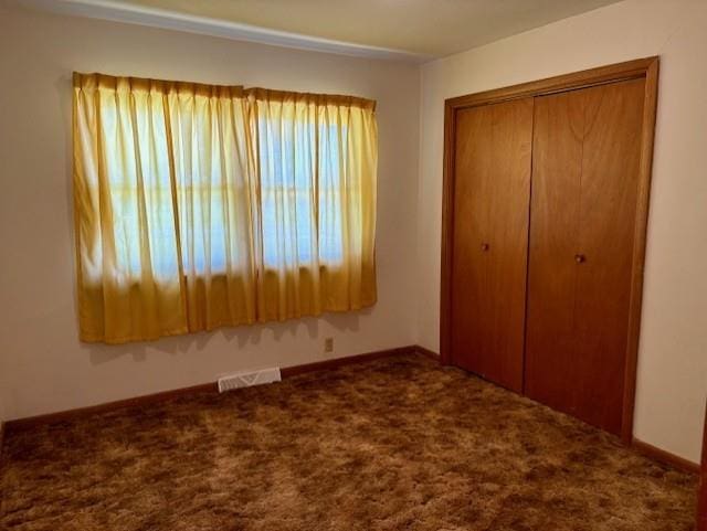 22025 Ness Rd, Parsons, KS 67357 - unfurnished bedroom featuring a closet, carpet, and baseboards