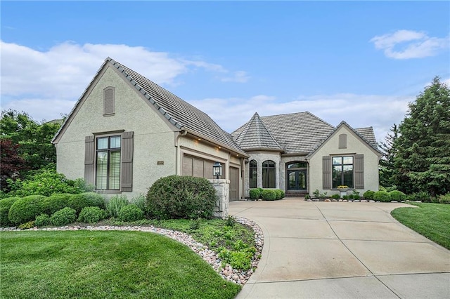 14008 Nicklaus Dr, Overland Park, KS 66223 - french country inspired facade featuring concrete driveway, an attached garage, stucco siding, and a front yard