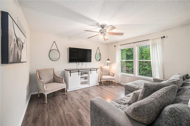 5862 SW Reed Ln, Trimble, MO 64492 - living room featuring a ceiling fan, wood finished floors, a textured ceiling, and baseboards