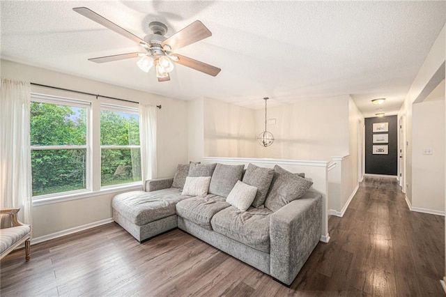 5862 SW Reed Ln, Trimble, MO 64492 - living area with a textured ceiling, dark wood finished floors, a ceiling fan, and baseboards