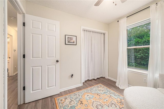 5862 SW Reed Ln, Trimble, MO 64492 - sitting room featuring a ceiling fan, wood finished floors, baseboards, and a textured ceiling