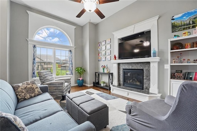 1106 E 14th St, Kearney, MO 64060 - living area featuring a ceiling fan, wood finished floors, a high end fireplace, and baseboards
