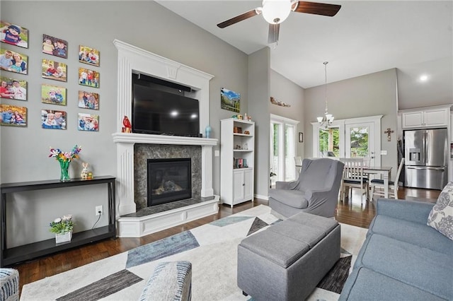 1106 E 14th St, Kearney, MO 64060 - living area with wood finished floors, a ceiling fan, a premium fireplace, and a chandelier