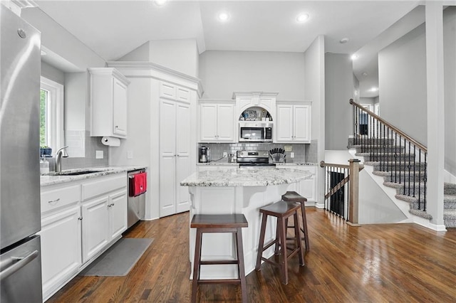 1106 E 14th St, Kearney, MO 64060 - kitchen with stainless steel appliances, white cabinets, a sink, backsplash, and recessed lighting
