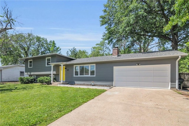 1018 S Elm St, Ottawa, KS 66067 - tri-level home with a chimney, concrete driveway, a garage, and a front yard