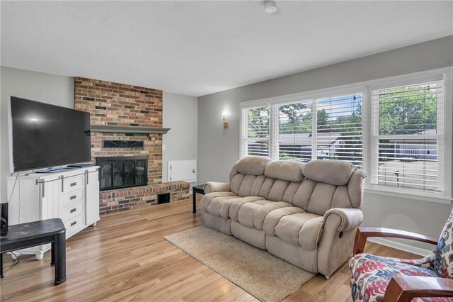 1018 S Elm St, Ottawa, KS 66067 - living area with light wood-style floors, a fireplace, and baseboards