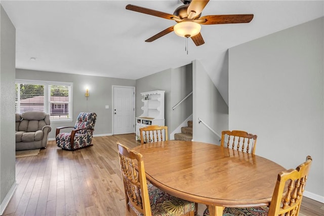 1018 S Elm St, Ottawa, KS 66067 - dining area with a ceiling fan, wood-type flooring, stairway, and baseboards
