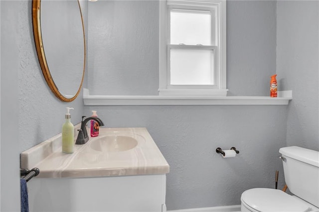 1018 S Elm St, Ottawa, KS 66067 - half bath with vanity, toilet, baseboards, and a textured wall