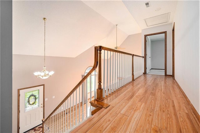 3304 Tepee Ct, Independence, MO 64057 - hallway featuring light wood finished floors, lofted ceiling, a chandelier, and an upstairs landing