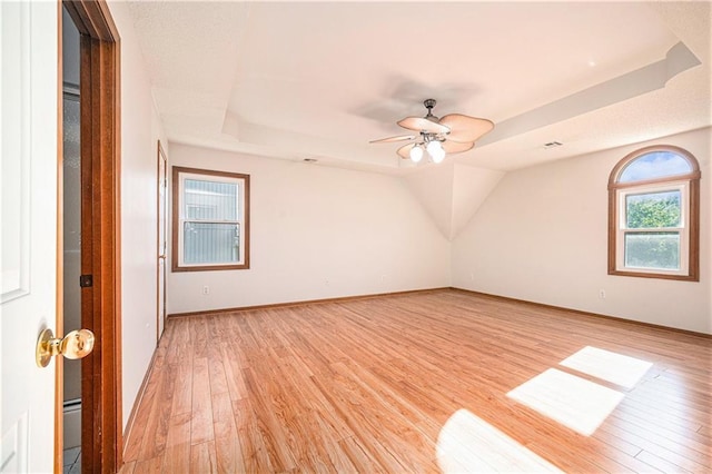 3304 Tepee Ct, Independence, MO 64057 - empty room featuring light wood-style floors, a tray ceiling, ceiling fan, and baseboards