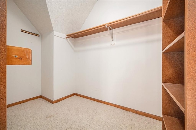 3304 Tepee Ct, Independence, MO 64057 - spacious closet featuring carpet flooring and vaulted ceiling