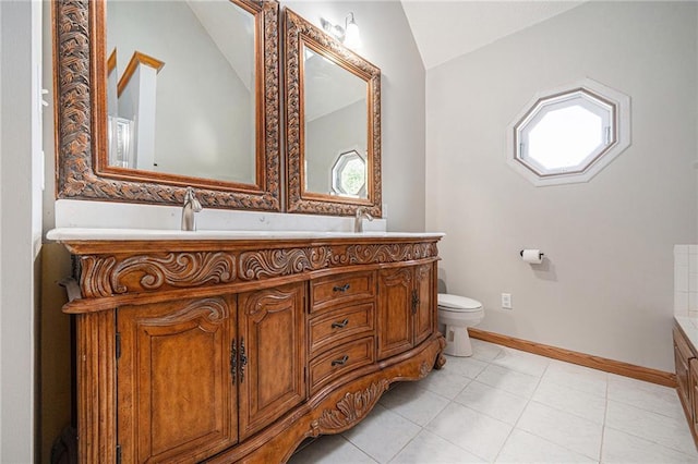 3304 Tepee Ct, Independence, MO 64057 - bathroom with vaulted ceiling, double vanity, toilet, tile patterned floors, and baseboards