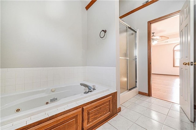 3304 Tepee Ct, Independence, MO 64057 - bathroom featuring a tub with jets, a stall shower, tile patterned floors, and baseboards
