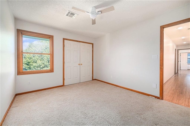 3304 Tepee Ct, Independence, MO 64057 - unfurnished bedroom featuring carpet floors, baseboards, a closet, ceiling fan, and a textured ceiling