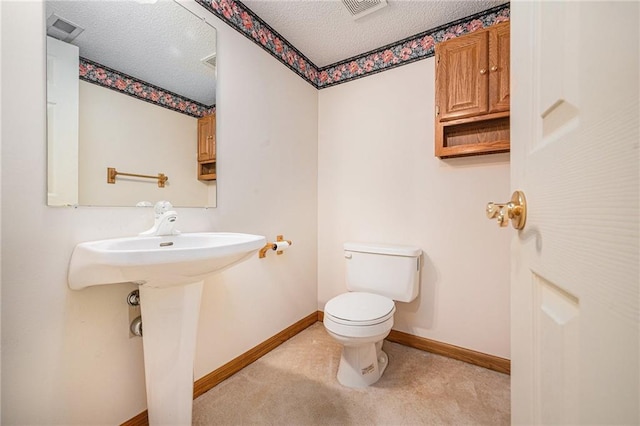 3304 Tepee Ct, Independence, MO 64057 - bathroom with a textured ceiling, toilet, and baseboards