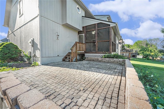 3304 Tepee Ct, Independence, MO 64057 - back of house featuring a sunroom and a patio area