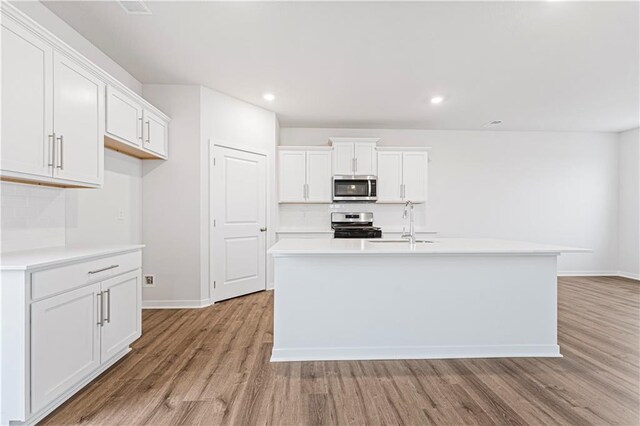 5004 NW 141st St, Platte City, MO 64079 - kitchen featuring stainless steel appliances, light wood finished floors, light countertops, backsplash, and recessed lighting