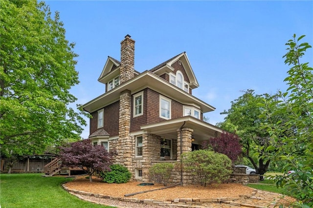 2301 Massachusetts St, Lawrence, KS 66046 - view of property exterior with a chimney, stone siding, a porch, and stairway