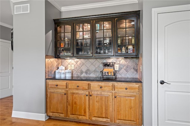 1602 SW Deer Run Rd, Oak Grove, MO 64075 - bar featuring crown molding, decorative backsplash, light wood-style floors, and baseboards