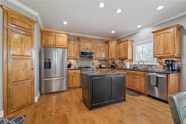 1602 SW Deer Run Rd, Oak Grove, MO 64075 - kitchen with appliances with stainless steel finishes, crown molding, a center island, backsplash, and light wood finished floors