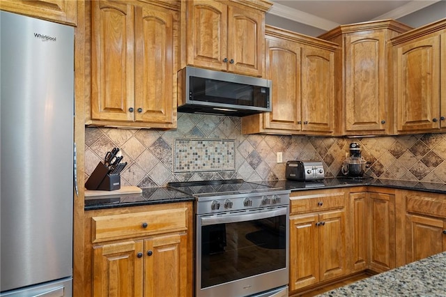 1602 SW Deer Run Rd, Oak Grove, MO 64075 - kitchen featuring appliances with stainless steel finishes, dark stone countertops, backsplash, brown cabinets, and crown molding