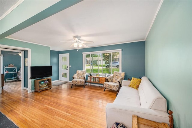 11410 W 68th Ter, Shawnee, KS 66203 - living room with a ceiling fan, crown molding, light wood-type flooring, and baseboards