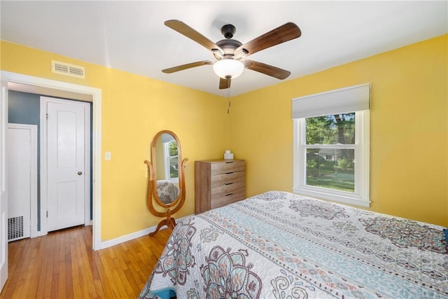 11410 W 68th Ter, Shawnee, KS 66203 - bedroom with light wood finished floors, baseboards, and a ceiling fan