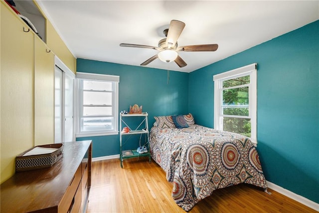 11410 W 68th Ter, Shawnee, KS 66203 - bedroom with wood finished floors, baseboards, a ceiling fan, and a closet