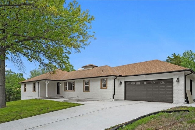 308 N 22nd St, Leavenworth, KS 66048 - ranch-style home with an attached garage, a front yard, driveway, and brick siding