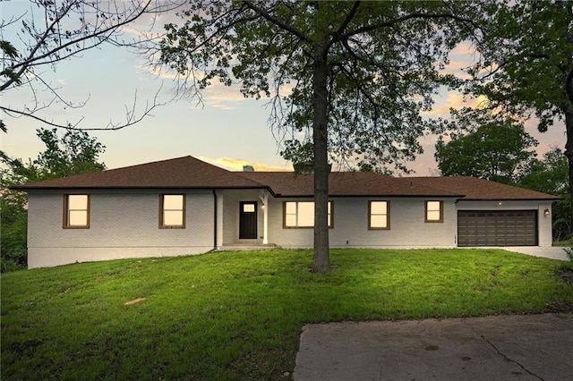 308 N 22nd St, Leavenworth, KS 66048 - single story home with a front lawn, a garage, concrete driveway, and brick siding