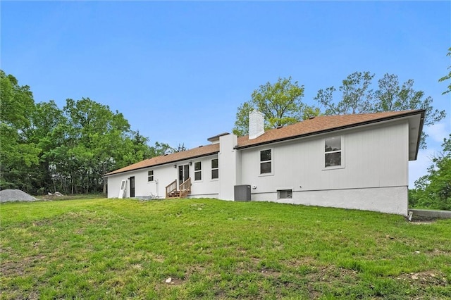 308 N 22nd St, Leavenworth, KS 66048 - back of house with entry steps, central AC unit, a chimney, and a lawn