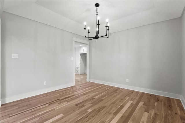 308 N 22nd St, Leavenworth, KS 66048 - unfurnished dining area featuring a chandelier, baseboards, and light wood finished floors