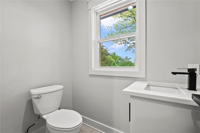 308 N 22nd St, Leavenworth, KS 66048 - bathroom featuring toilet, baseboards, vanity, and tile patterned flooring