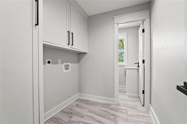 308 N 22nd St, Leavenworth, KS 66048 - laundry area featuring cabinet space, electric dryer hookup, light marble finish floors, washer hookup, and baseboards