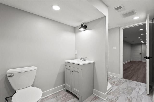 308 N 22nd St, Leavenworth, KS 66048 - bathroom with vanity, baseboards, toilet, recessed lighting, and marble look tile flooring