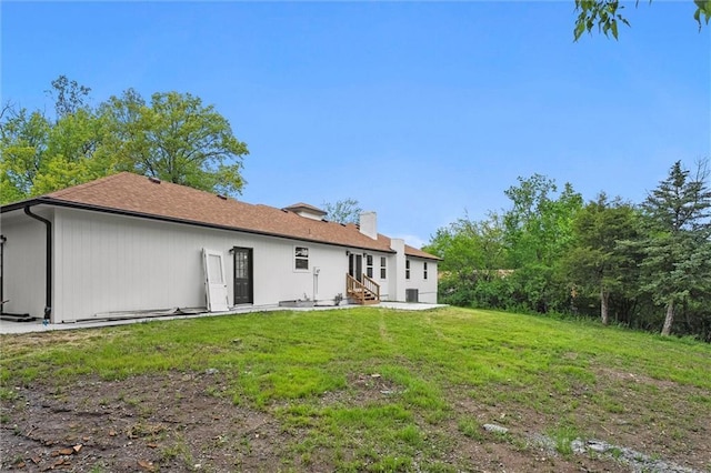 308 N 22nd St, Leavenworth, KS 66048 - back of property with entry steps, a chimney, and a lawn