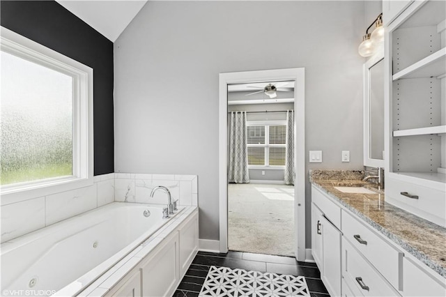 10429 W 170th Pl, Overland Park, KS 66221 - full bath with a tub with jets, vanity, tile patterned flooring, a ceiling fan, and lofted ceiling