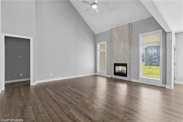10429 W 170th Pl, Overland Park, KS 66221 - unfurnished living room with high vaulted ceiling, ceiling fan, wood finished floors, and a multi sided fireplace