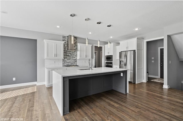 10429 W 170th Pl, Overland Park, KS 66221 - kitchen featuring stainless steel appliances, wall chimney range hood, light countertops, a large island, and recessed lighting