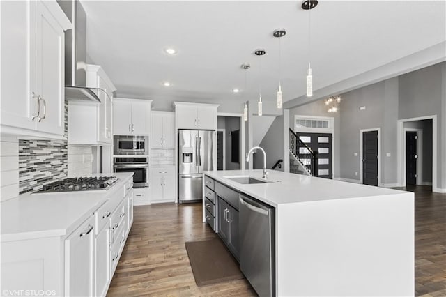 10429 W 170th Pl, Overland Park, KS 66221 - kitchen with stainless steel appliances, wall chimney exhaust hood, backsplash, light countertops, and recessed lighting