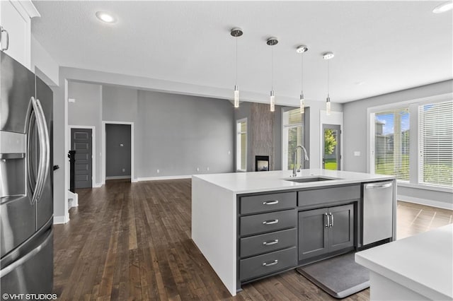 10429 W 170th Pl, Overland Park, KS 66221 - kitchen featuring stainless steel appliances, light countertops, gray cabinetry, dark wood finished floors, and hanging light fixtures