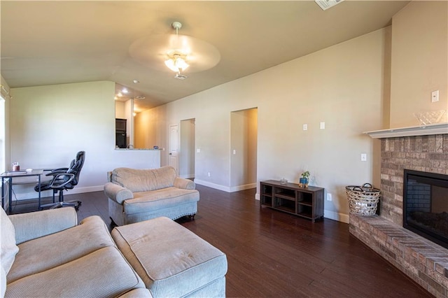 102 Zachary Ln, Carl Junction, MO 64834 - living area featuring a fireplace, wood finished floors, vaulted ceiling, and baseboards
