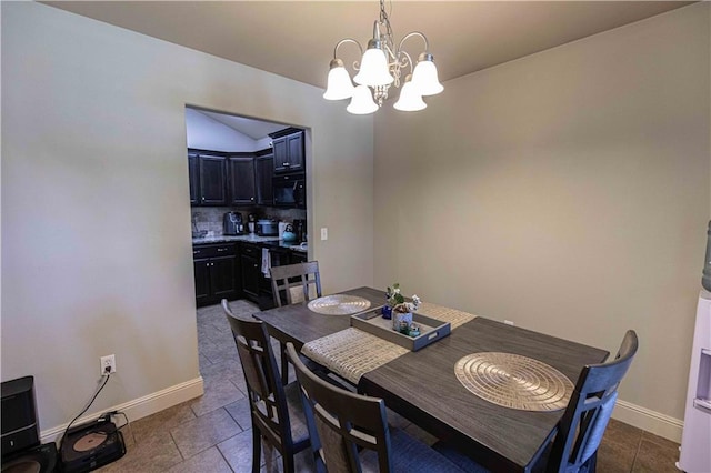 102 Zachary Ln, Carl Junction, MO 64834 - dining room featuring a chandelier, baseboards, and dark tile patterned floors