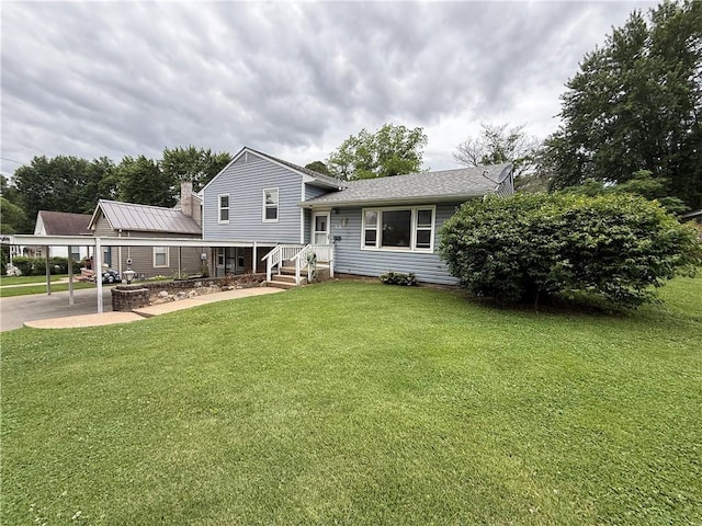 316 N 18th St, Lexington, MO 64067 - back of property with a carport, a yard, and a chimney