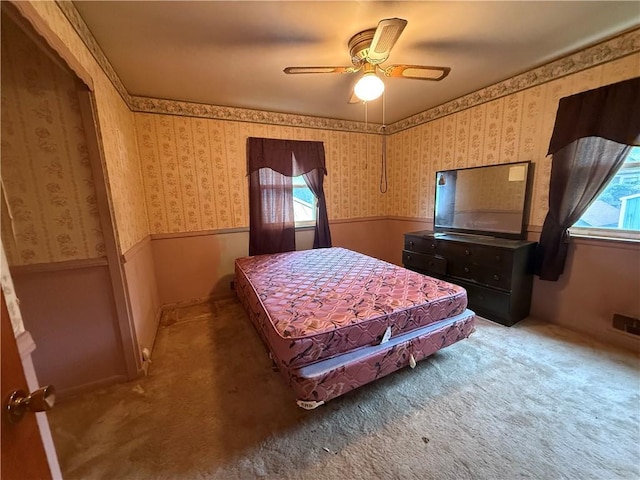 316 N 18th St, Lexington, MO 64067 - bedroom featuring carpet floors, a wainscoted wall, wallpapered walls, and a ceiling fan