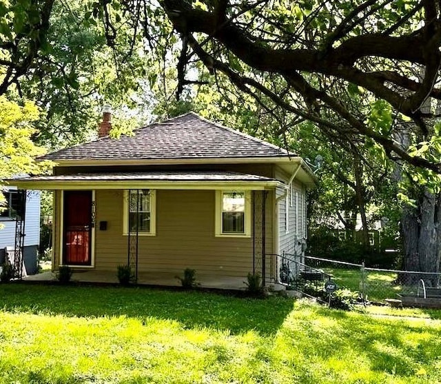 8106 Oak St, Kansas City, MO 64114 - back of house featuring a chimney and roof with shingles
