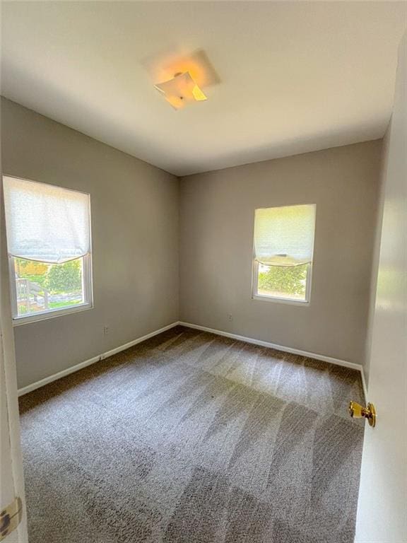 8106 Oak St, Kansas City, MO 64114 - unfurnished room with carpet floors, healthy amount of natural light, and baseboards