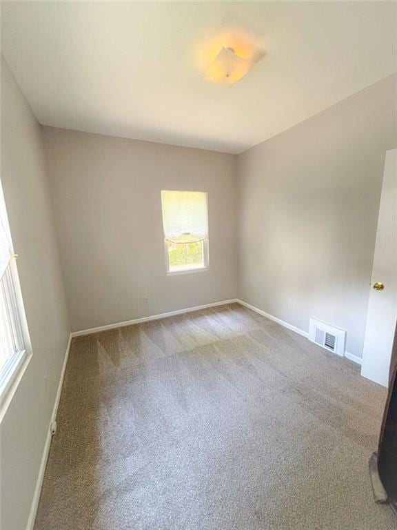 8106 Oak St, Kansas City, MO 64114 - carpeted empty room with baseboards